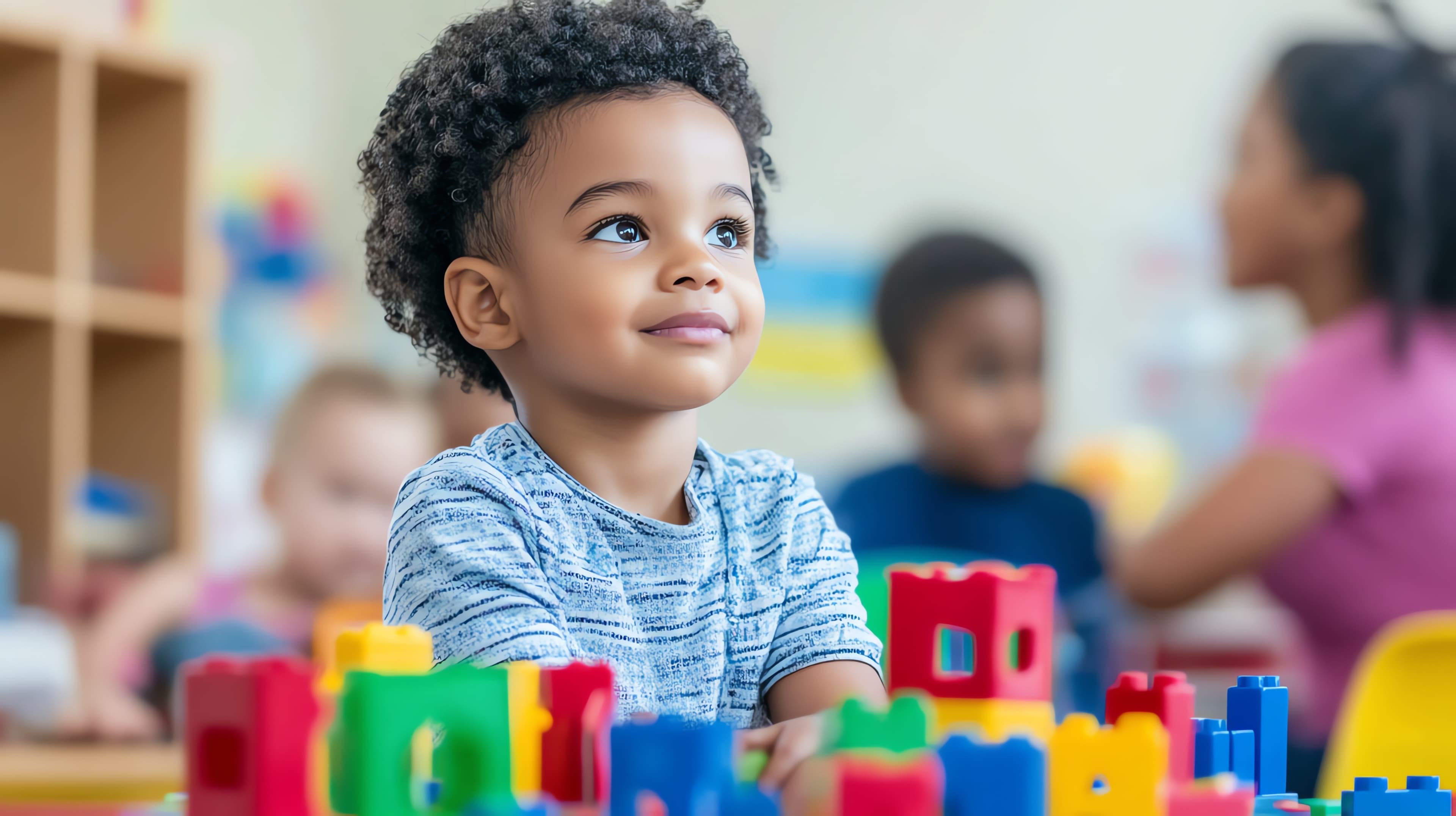 Young boy playing with colorful building blocks.